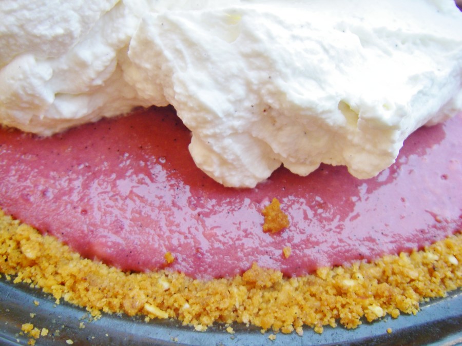 Spreading whipped cream over pie